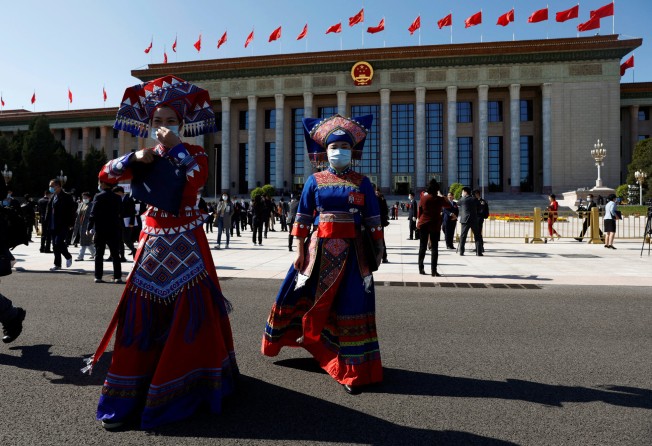 Delegates in ethnic minority costumes leave the Great Hall of the People after the opening ceremony of the 20th party congress on October 16. Photo: Reuters