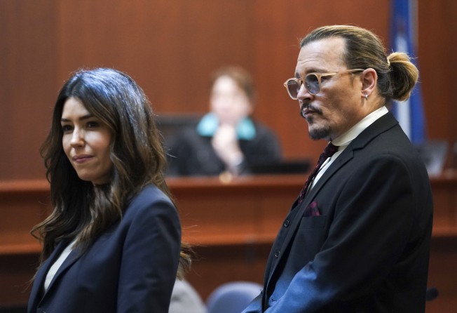 Actor Johnny Depp stands next to his lawyer, Camille Vasquez at the Fairfax County Circuit Courthouse in Fairfax, Virginia, US in May. Photo: Pool Photo via AP