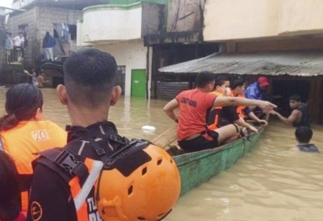 Rescuers evacuate residents at a flooded village in Tuguegarao city, Cagayan province, northern Philippines on Sunday. Photo: Philippine Coast Guard via AP
