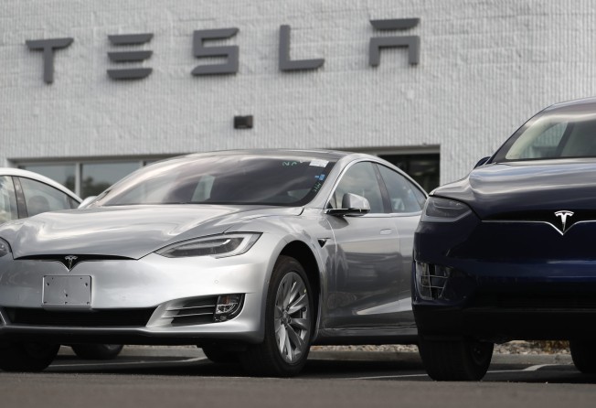 A Model 3 sedan sits next to a Model X on display outside a Tesla showroom in Littleton, Colorado, in July 2018. Photo: AP Photo