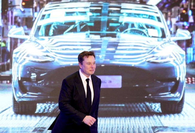 Tesla Inc. CEO Elon Musk walks next to a screen showing an image of Tesla Model 3 car during an opening ceremony for Tesla China-made Model Y programme in Shanghai, China, in January 2020. Photo: Reuters