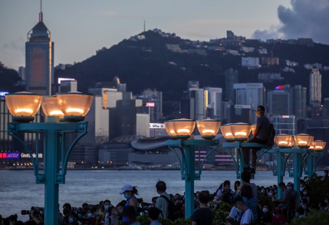 People gather to watch the “super blood moon” over the Hong Kong skyline on May 26, 2021. Photo: Bloomberg