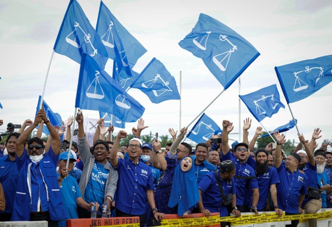 Supporters of the Barisan Nasional party in Malaysia support candidates as they arrive to submit nomination documents for the coming general election. Photo: dpa