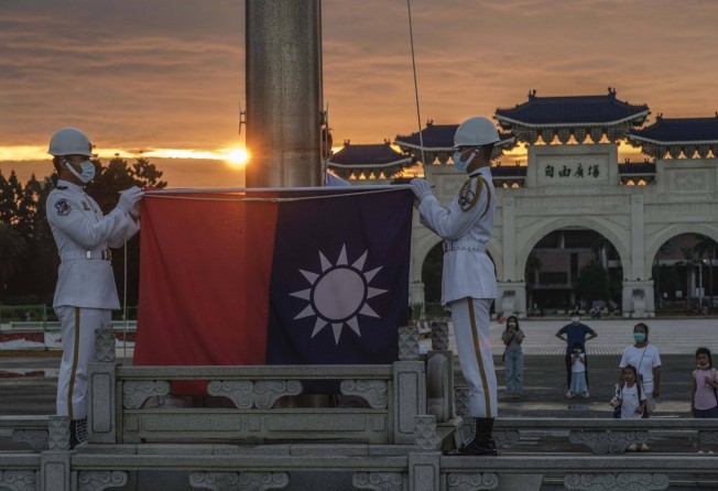 Soldiers lower the Republic of China flag at the Chiang Kai-shek Memorial Hall in Taipei in August. Photo: Bloomberg