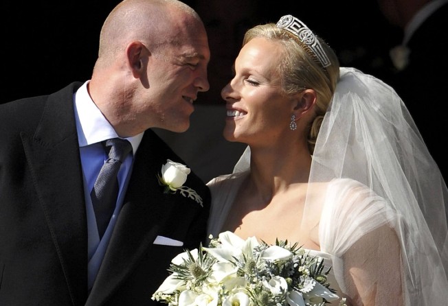 England rugby player Mike Tindall (left) prepares to kiss his new bride Britain’s Zara Phillips, granddaughter of Queen Elizabeth, after their wedding ceremony at Canongate Kirk in Edinburgh, Scotland, in July 2011. Photo: AFP