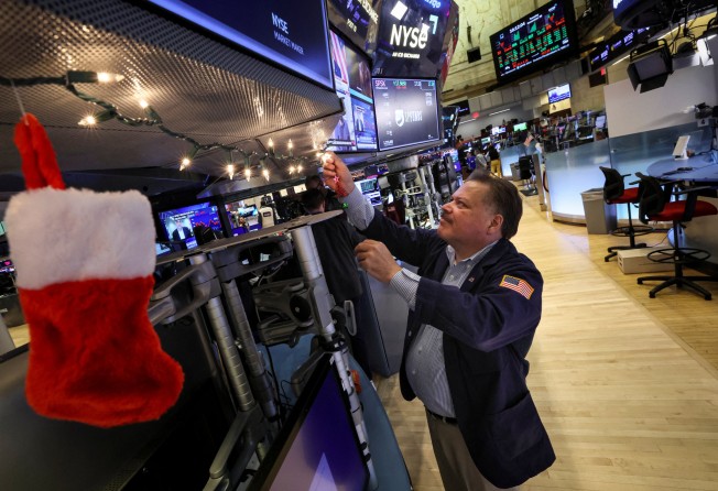 A trader hangs Christmas decorations on a trading post on the floor of the New York Stock Exchange in New York City. Global stocks, represented by the MSCI World Index, delivered returns of 16.5 per cent in 2020 and 22 per cent in 2021. Photo: Reuters