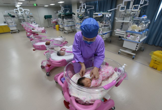 A nurse takes care of newborn babies in a maternity hospital in Fuyang in eastern China’s Anhui province in August. Photo: Getty Images.