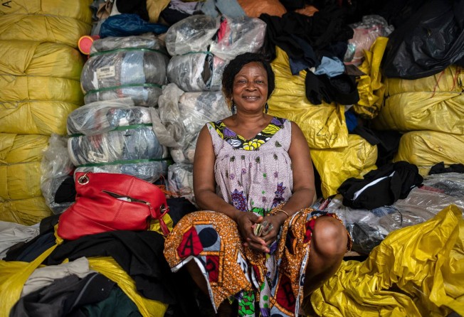 Janet Dansua at her clothing stall. Photo: Andrew Caballero-Reynolds / Bloomberg