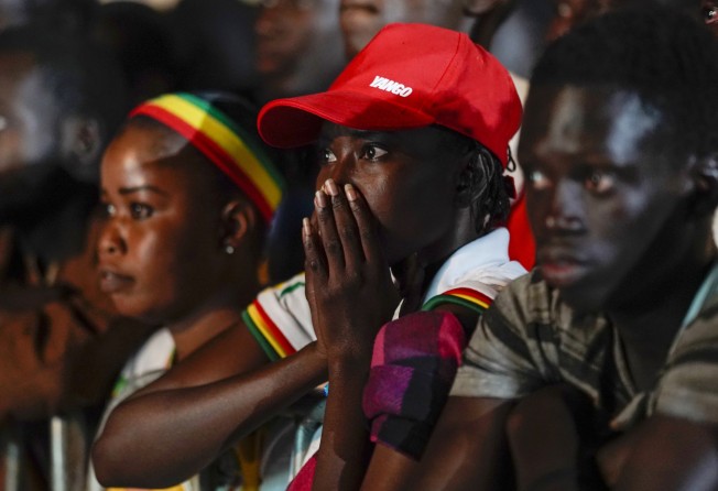 Senegal fans watch their team’s World Cup match against England on a video screen set up at a fan zone in Dakar, Senegal on Sunday. Photo: AP
