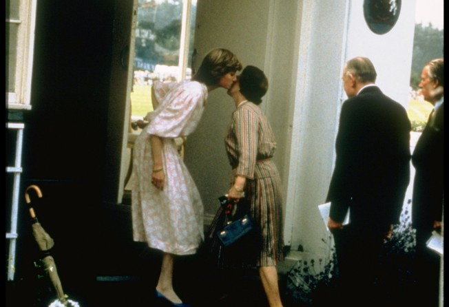 Lady Diana Spencer kissing her mother-in-law to be, Queen Elizabeth, in greeting before going to watch fiancé Prince Charles play polo, in 1981. Photo: Getty Images