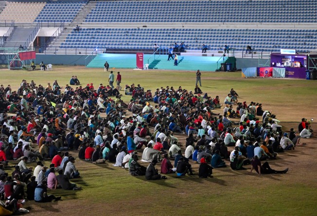 Qatar’s migrant workers watch the Qatar 2022 World Cup round of 16 football match between Morocco and Spain at the Asian Town cricket stadium, on the outskirts of Doha. The stadium has become a daily draw for thousands of the poorest workers who live in nearby dormitories away from Doha’s glitzy shopping malls and restaurants. Photo: AFP