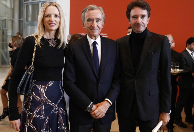 Head of LVMH luxury group, Bernard Arnault (centre), his daughter Louis Vuitton executive vice-president Delphine Arnault (left) and his son LVMH communications head Antoine Arnault (right) arrive to open the exhibition of The Morozov Collection, Icons of Modern Art at Fondation Louis Vuitton in Paris, in September 2021. Photo: AFP