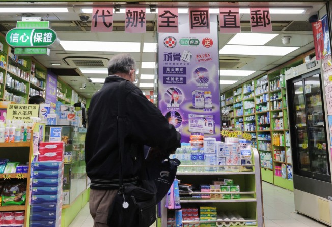 A pharmacy in Hong Kong’s Wan Chai with a sign indicating it can deliver supplies to the mainland. Photo: Jelly Tse