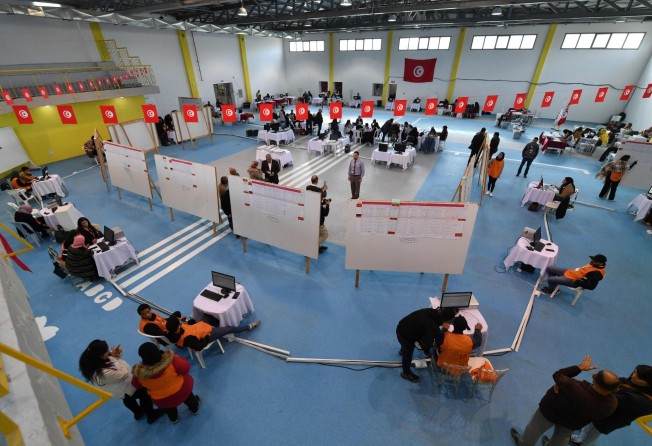 Members of the Tunisian electoral commission count votes on Sunday in Tunis, Tunisia. Photo: AFP