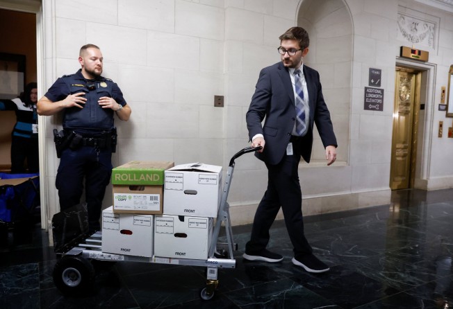 US House Ways and Means Committee staff members transport boxes of documents after a committee meeting to discuss Donald Trump’s tax returns. Photo: Reuters