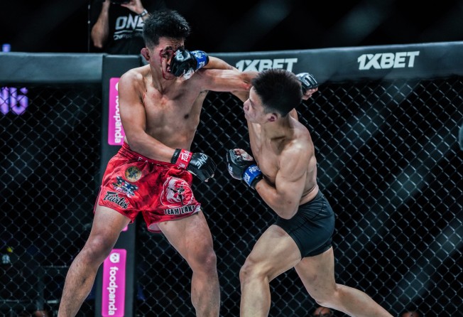 Hu Yong cracks Geje Eustaquio with an overhand right.