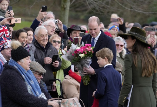 Prince William, Prince George and Kate, Princess of Wales, speak to members of the public in Norfolk, England on Christmas Day. Photo: AP