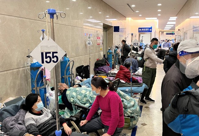 Patients lie on beds in a hallway in the emergency department of Shanghai’s Zhongshan Hospital earlier this month. Photo: Reuters