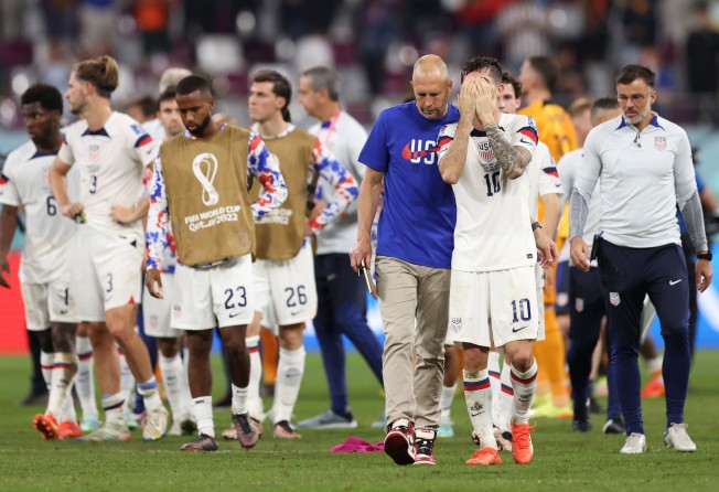 Head coach Gregg Berhalter and Christian Pulisic react after the US’ elimination from the 2022 World Cup in Qatar. Photo: TNS