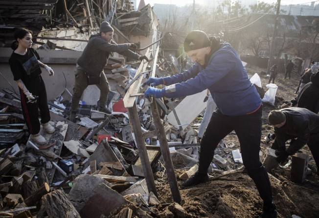 Volunteers clean debris at the site of an earlier Russian missile attack in Kyiv, Ukraine on Tuesday. Photo: EPA-EFE