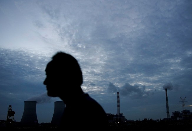 A man walks past a coal-fired power plant in Shanghai on October 14, 2021. Contrary to previous strict controls on coal to cut emissions, China’s coal output has been boosted since the second half of 2021. Photo: Reuters