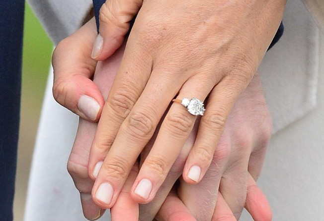 Meghan Markle shows off her engagement ring while holding Prince Harry’s hand. Photo: @meghanmarklefashion/Instagram