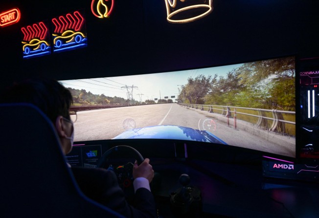 An attendee plays a racing video game featured on a Samsung Electronics 57-inch Odyssey Neo G9 ultra-wide screen display during CES 2023. Photo: AFP