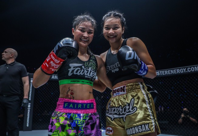 Stamp Fairtex and Supergirl pose together after their clash at ONE Fight Night 6.