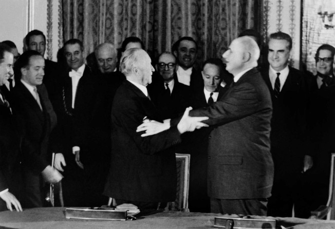 French President Charles de Gaulle (right) and German Chancellor Konrad Adenauer (left) hug each other as they hold the signing ceremony for the Elysee Treaty in Paris on January 22, 1963. Photo: AFP
