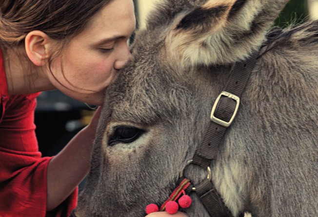 Sandra Drzymalska and one of the donkeys in a still from “O”.