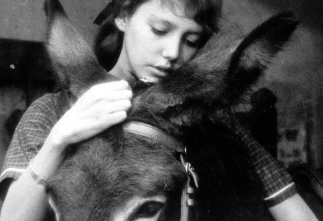 Anne Wiazemsky and her donkey co-star in a still from “Au Hasard Balthazar” (1966).