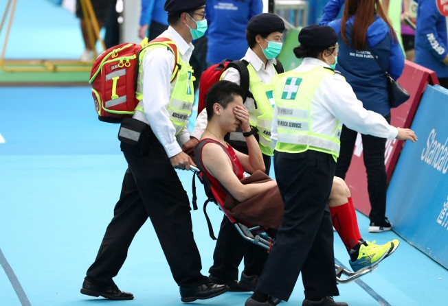 A runner is taken away by ambulance at the finish line at Victoria Park in Causeway Bay, during the 2019 Standard Chartered Hong Kong Marathon. Photo: Nora Tam