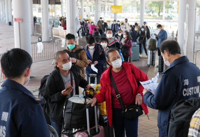 Travellers in Hong Kong crossing over to the mainland at Shenzhen Bay present their PCR test results. Photo: Sam Tsang