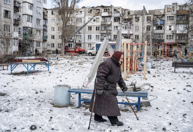A woman walks through a playground in Pokrovsk, in Ukraine’s Donetsk region, on February 15 after a nearby block of flats was badly damaged by a Russian missile. Photo: Reuters