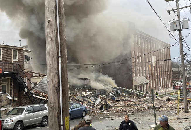 Emergency workers at the site of a deadly explosion at a chocolate factory in West Reading, Pennsylvania on Friday. Photo: Reading Eagle via AP