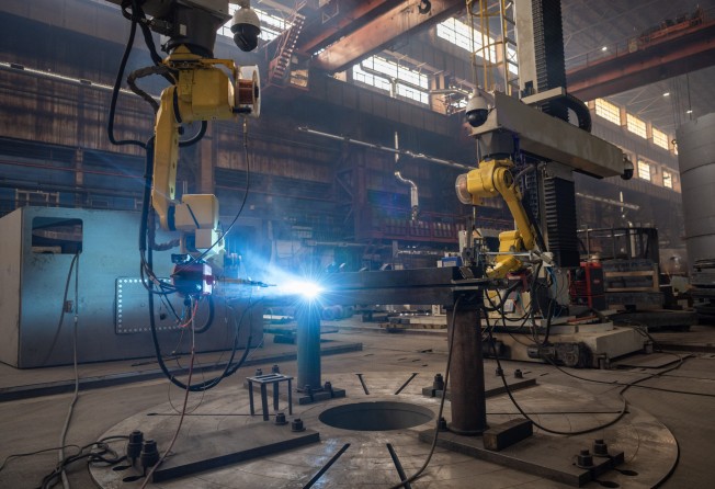 Welding robots work at the workshop of Harbin Electric Machinery Company in Harbin, in northeastern Heilongjiang province, on March 29. Photo: Xinhua