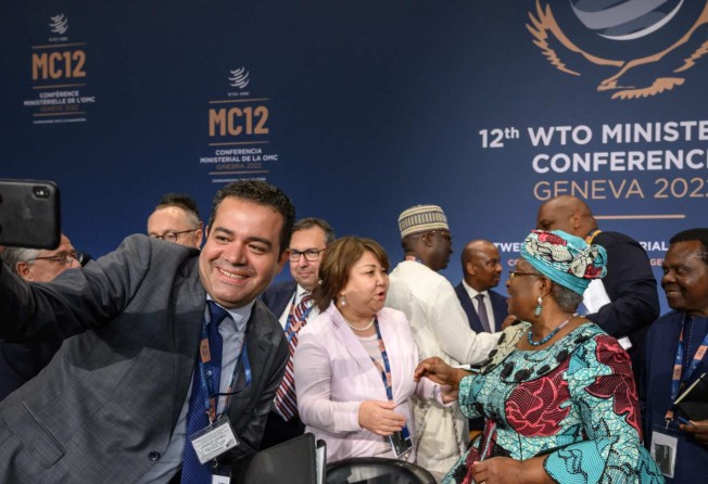 Delegates react with WTO director general Ngozi Okonjo-Iweala (second right) after the closing session of the ministerial conference in Geneva on June 17, 2022, as an agreement was reached on what she called an “unprecedented package of deliverables”. Photo: AFP