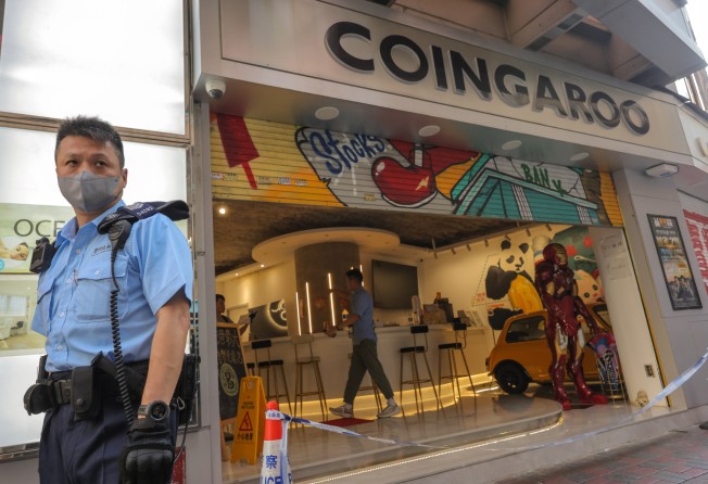 Police officers raided Coingaroo, a cryptocurrency exchange in Hong Kong with ties to JPEX. Photo: Jelly Tse