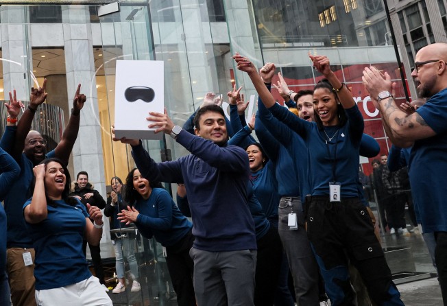 A customer walks out of an Apple store on Fifth Avenue, New York City, with a Vision Pro headset. Photo: Reuters