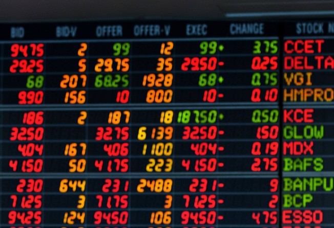 A Thai investor looks at an electronic display of share prices at a private trading company in Bangkok. Photo: AFP