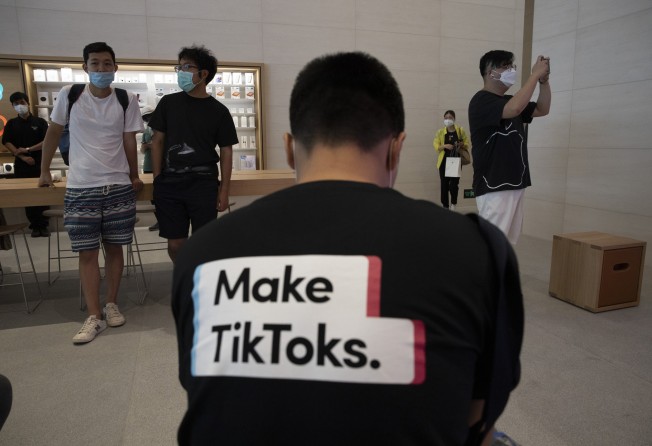 In this July 17, 2020, file photo, a man wearing a shirt promoting TikTok is seen at an Apple Store in Beijing. On the mainland, ByteDance operates Douyin, the Chinese-language version of TikTok. Photo: AP