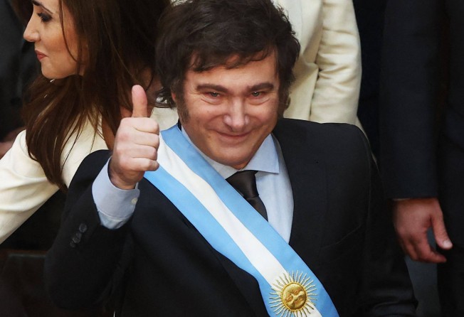 Argentina’s Javier Milei gives the thumb up after receiving the presidential sash and baton during his inauguration ceremony at the Congress in Buenos Aires in December 2023. Photo: AFP