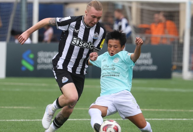 Newcastle United’s Alfe Harrison (left) fights for the ball with Football Club’s Yam Pung-pang at the HKFC Soccer Sevens. Photo: Yik Yeung-man