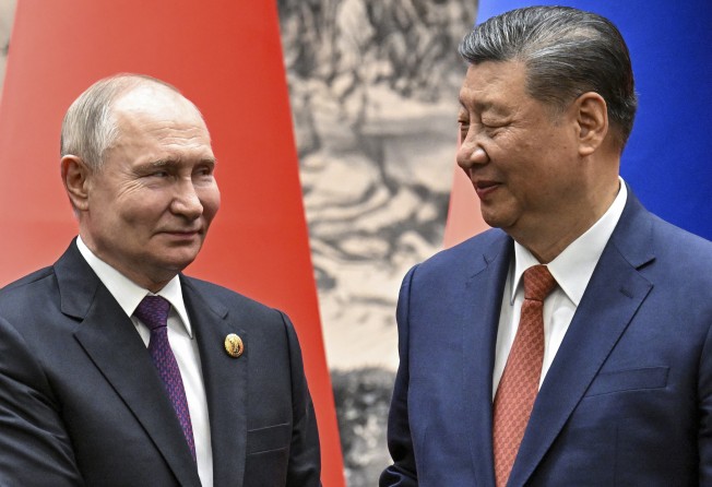 Russian President Vladimir Putin and Chinese President Xi Jinping shake hands prior to their talks in Beijing in May. Photo: Sputnik, Kremlin Pool Photo via AP
