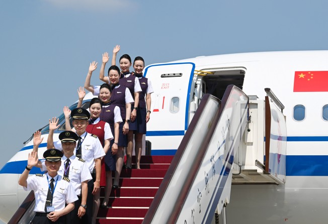 Air China crew pose with the airline’s first C919 jet on Thursday, shortly after its arrival at Beijing Capital International Airport. Photo: Xinhua