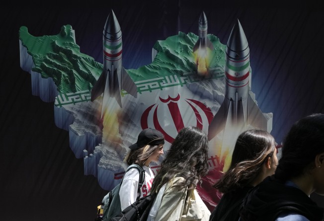 Missiles are depicted launching from Iran in a banner on a building in northern Tehran, Iran. Photo: AP