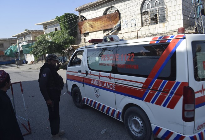 An ambulance drives past a checkpoint leading to the site where Pakistani Taliban militants attacked police officers in Bannu, Pakistan on Monday. Photo: EPA-EFE