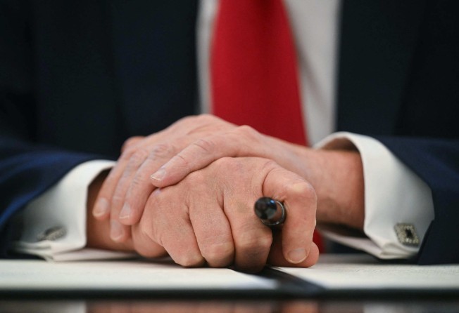 US President Donald Trump holds a marker as he signs an executive order in the White House. Trump’s tariff policies are forcing multinationals to rethink their supply chain strategies. Photo: AFP