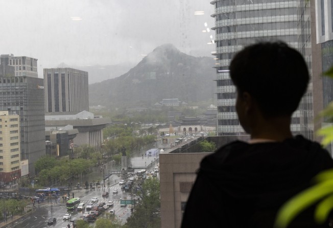 A North Korean defector looks out from a balcony across Seoul, South Korea. Thousands of North Koreans have fled the country since the late 1990s, but the numbers have dwindled drastically in recent years. Photo: EPA-EFE