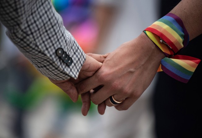 An LGBTQ couple holds hands during an event to raise awareness of gay rights in Hong Kong. Photo: AFP